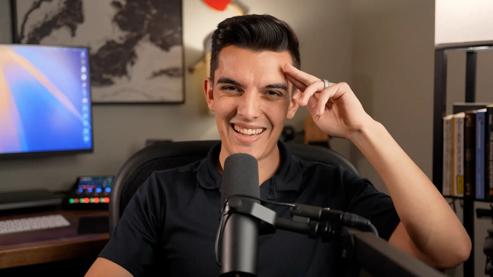 Joshua Sanderford smiling at his recording desk